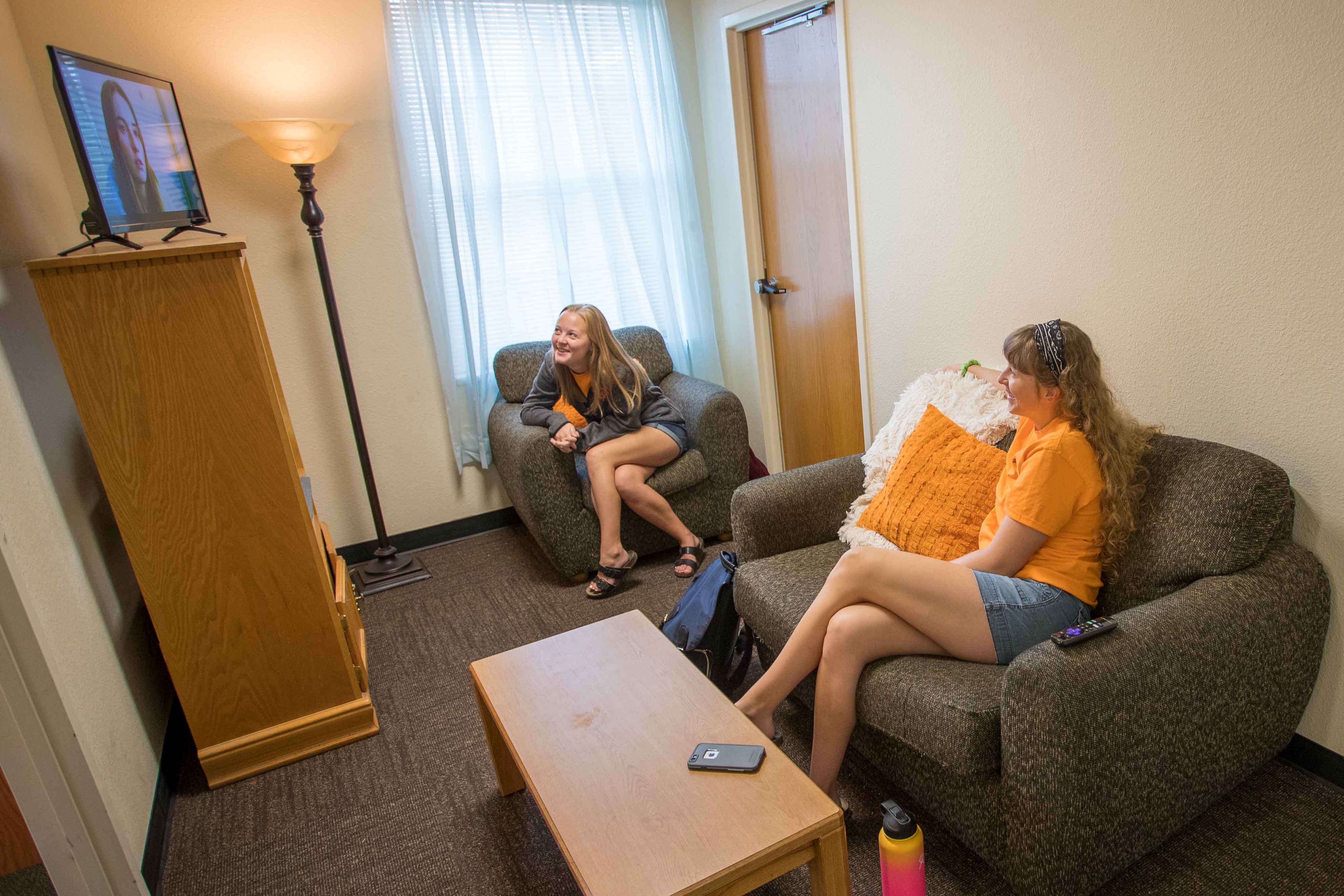 Bennett Hall Living Space. two students watching tv