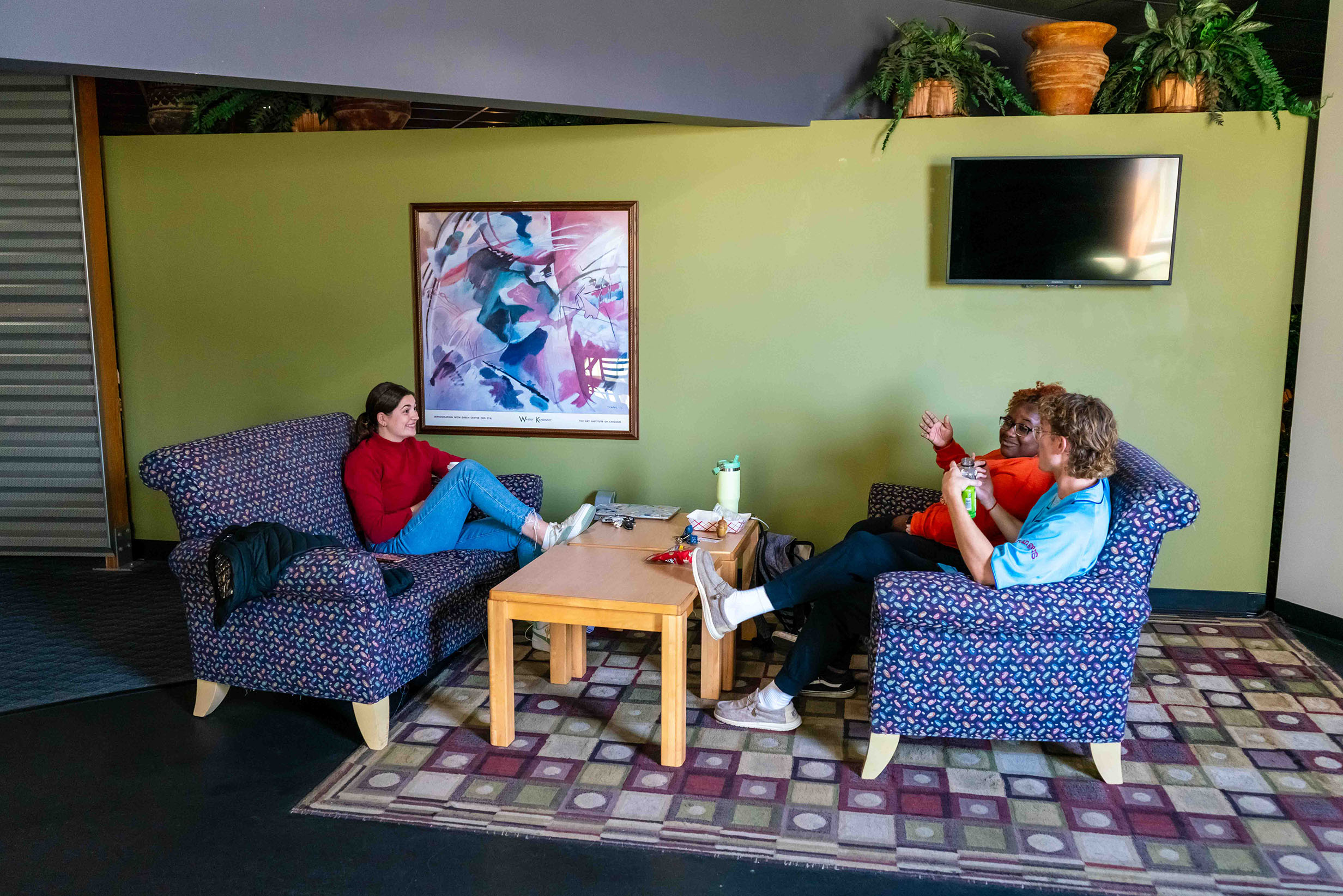 students sitting in Bennett Hall lobby