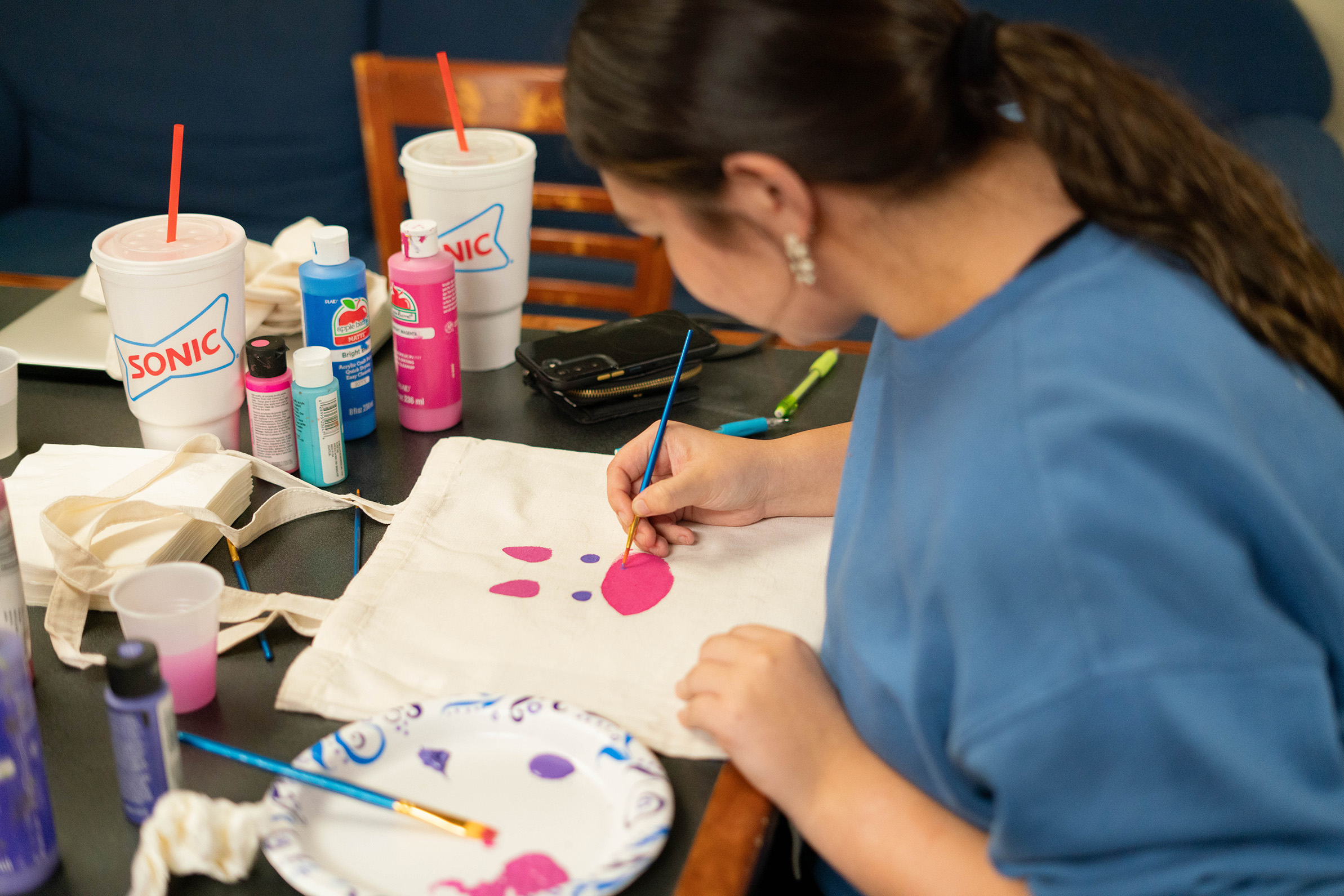 student painting a cute animal at RHA paint night