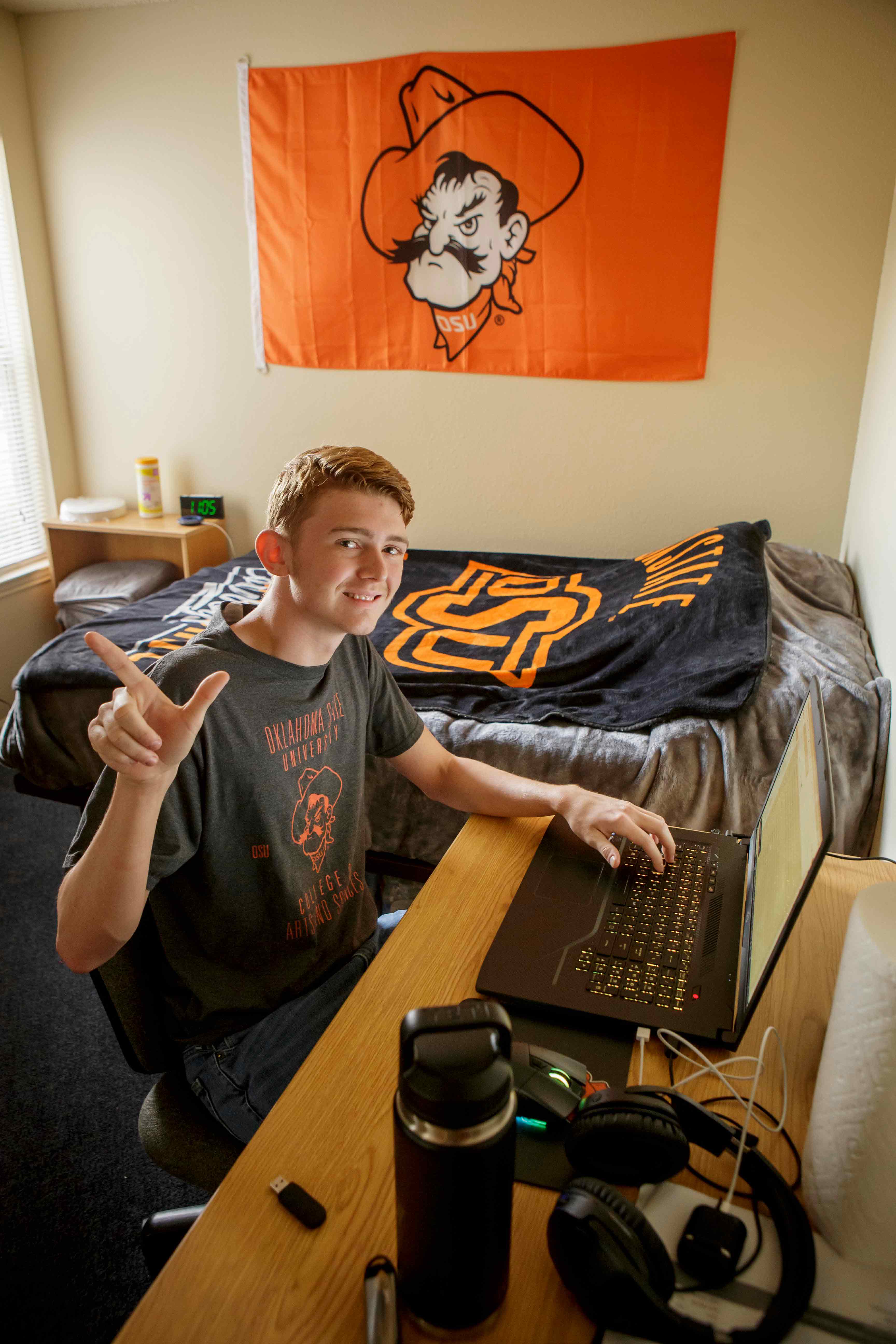male student smiling at his desk in Patchin-Jones Hall