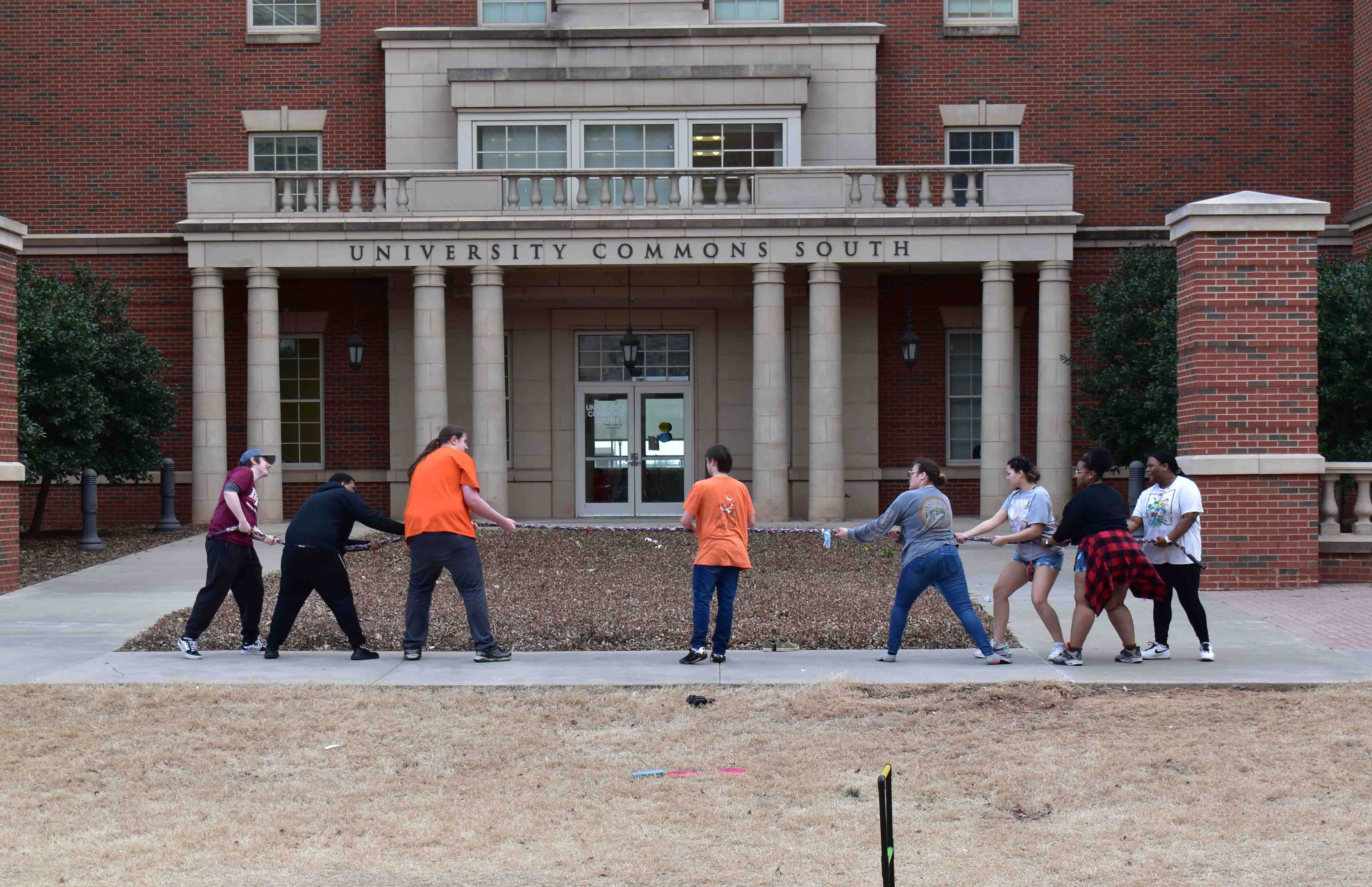 Students playing tug of war infront of the commons