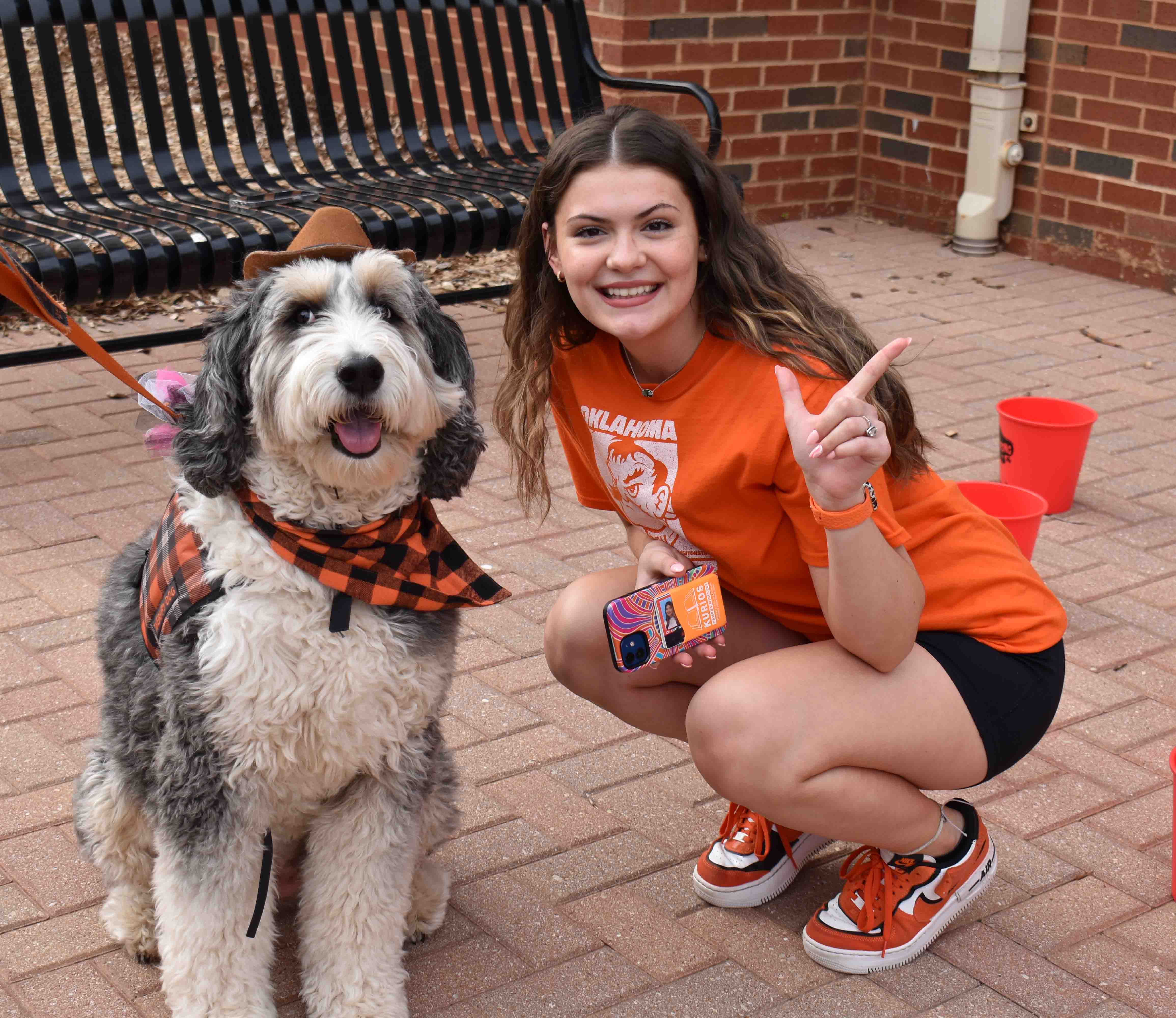 girl smiling next to a pete's pet possee dog