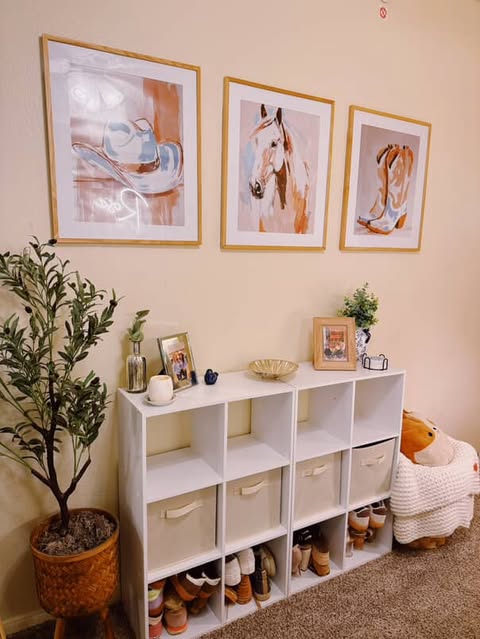 a decorated area of a ResHall with paintings, a dresser and plants
